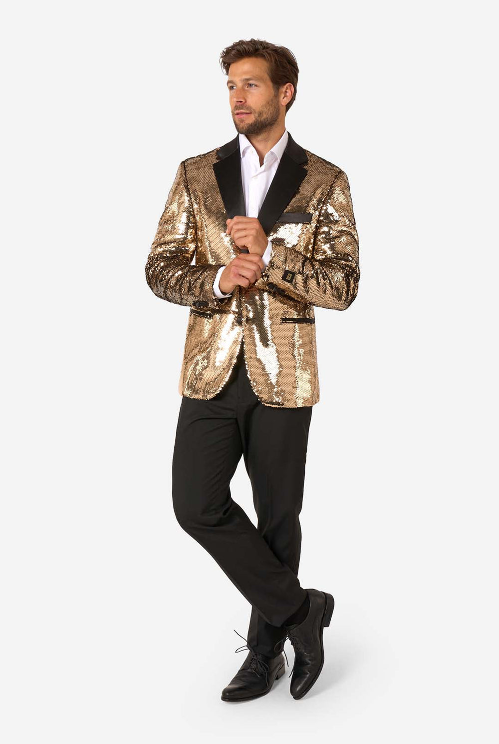 Man wearing a gold sequin blazer with black lapels on a white background