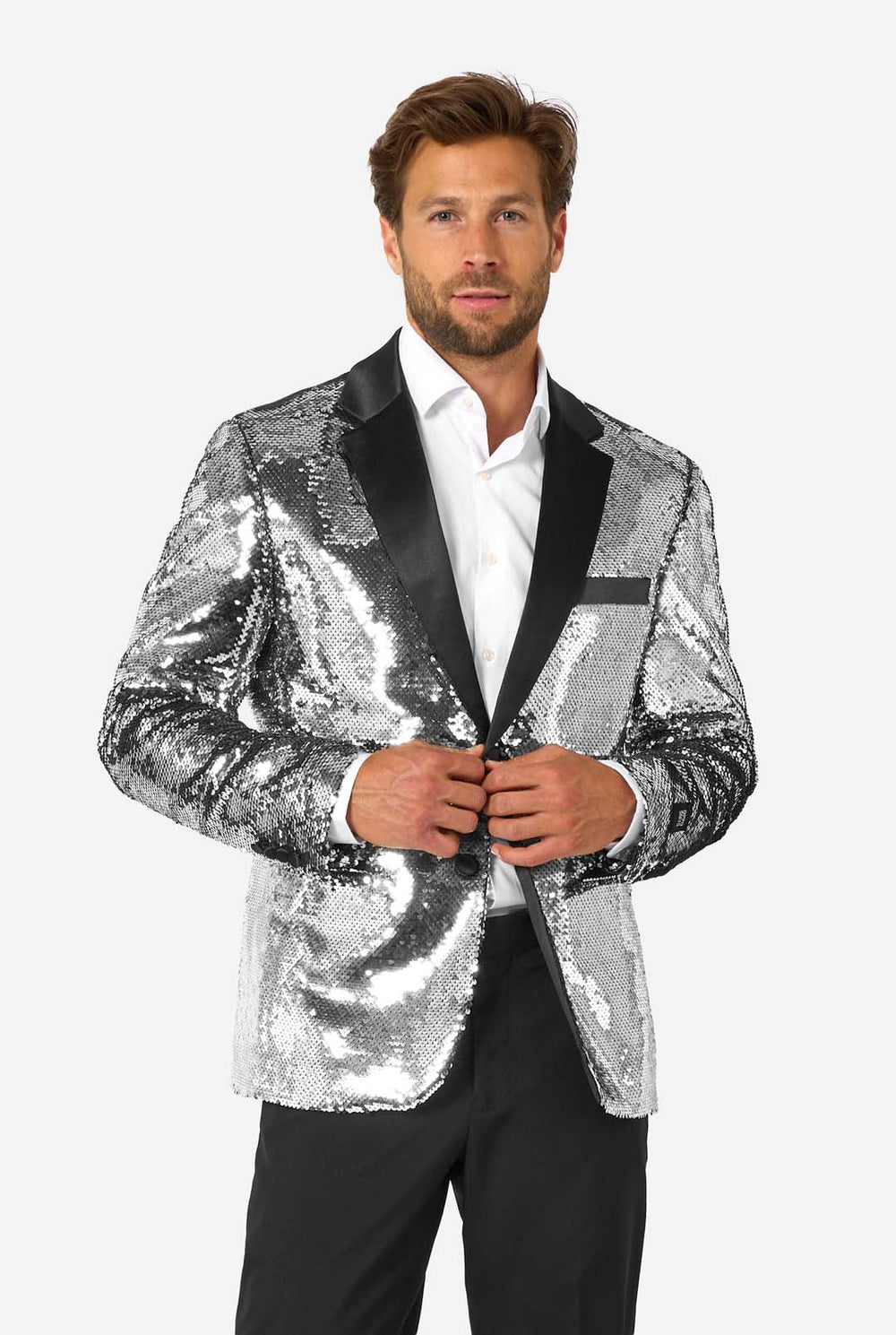 Man wearing a silver sequin blazer with black lapels on a white background