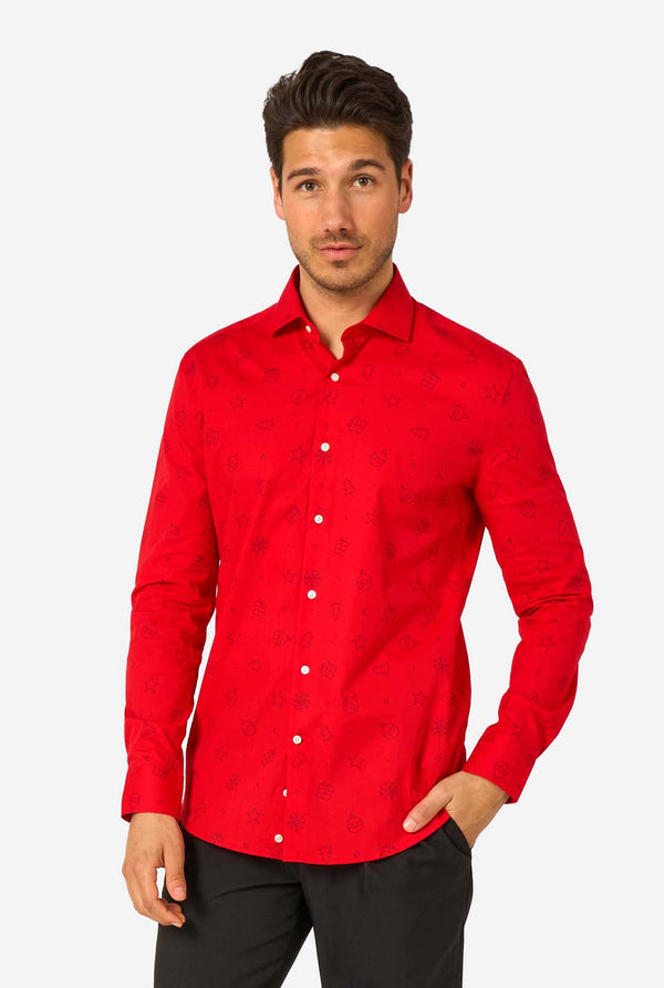 Man wearing red dress shirt with black outlined Christmas icons and black pants.