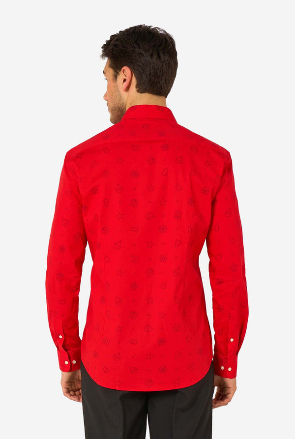 Man wearing red dress shirt with black outlined Christmas icons and black pants. View from the back.