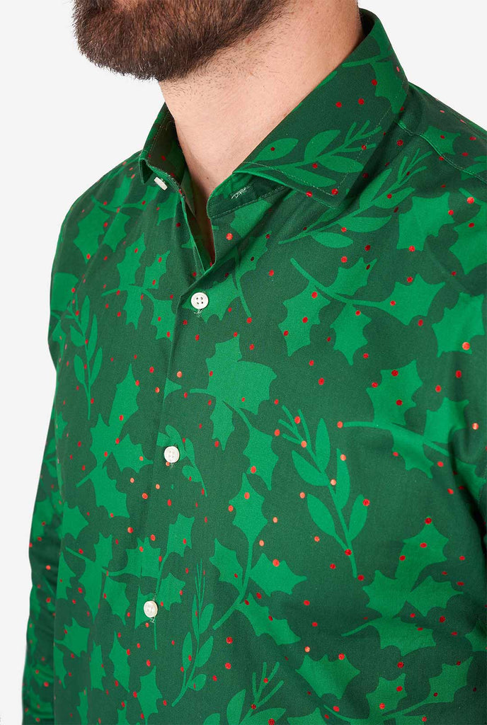 Man wearing green Christmas dress shirt with holly and mistletoe print