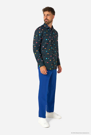 Image of a man wearing a black shirt with Pac-Man print and a blue pants. Full body image.