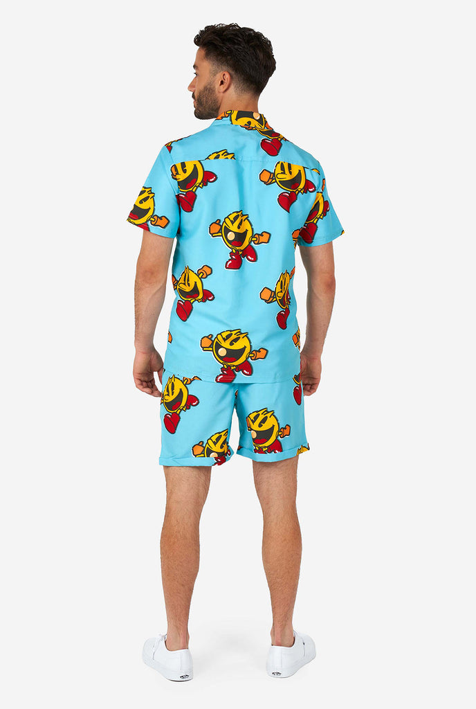 Man wearing blue summer shorts and shirt, with Pac-Man print