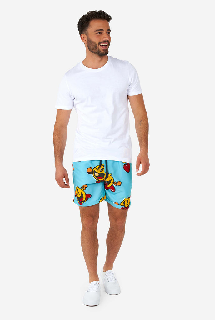 Man wearing blue summer shorts and shirt, with Pac-Man print