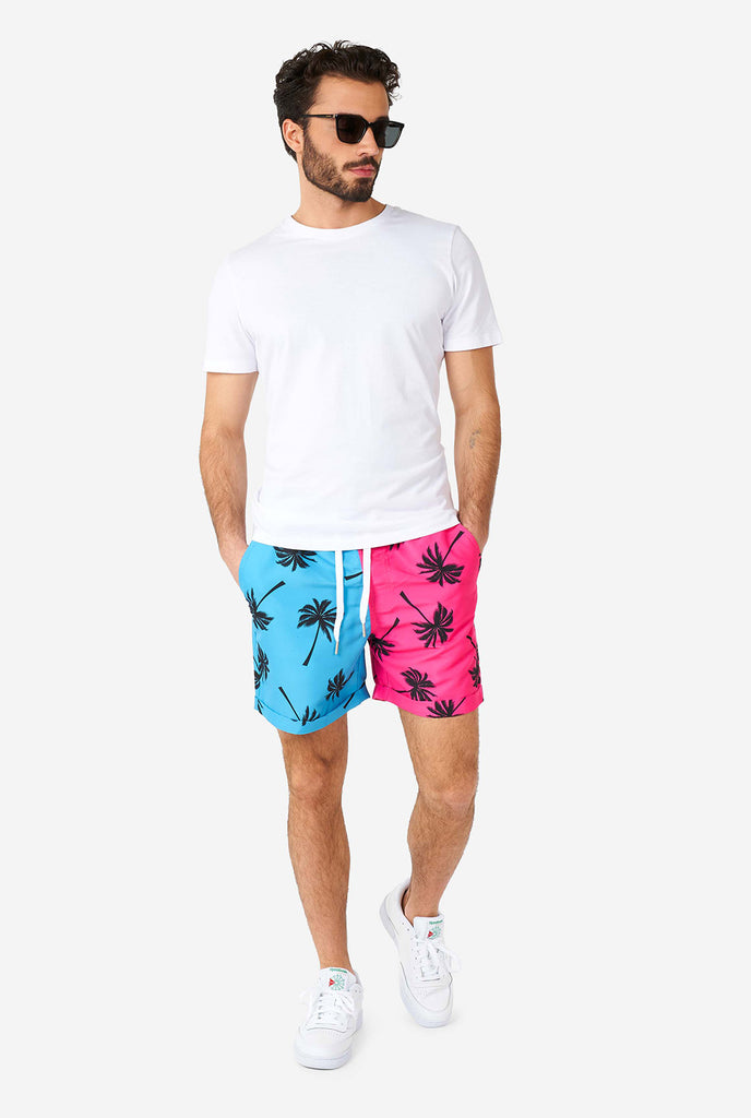 Man wearing summer set consisting of shorts and shirt
