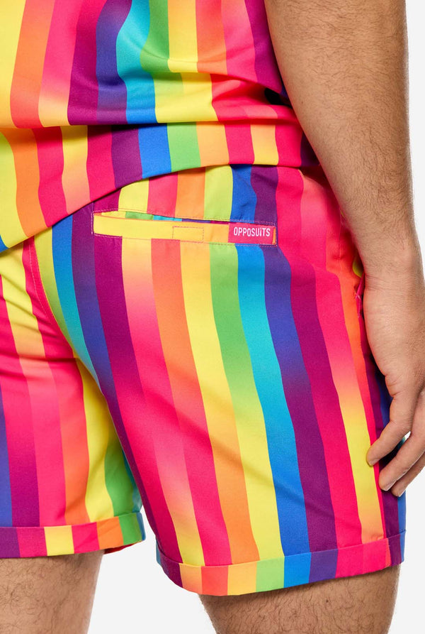 A man is wearing a vertically striped rainbow-colored summer set, consisting of shirt and shorts.Close up of the short and only showing the back.