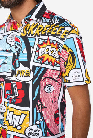 Colorful comic book style shirt with graphic designs and text, close up.