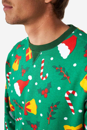Man wearing green Christmas sweater with Christmas icons