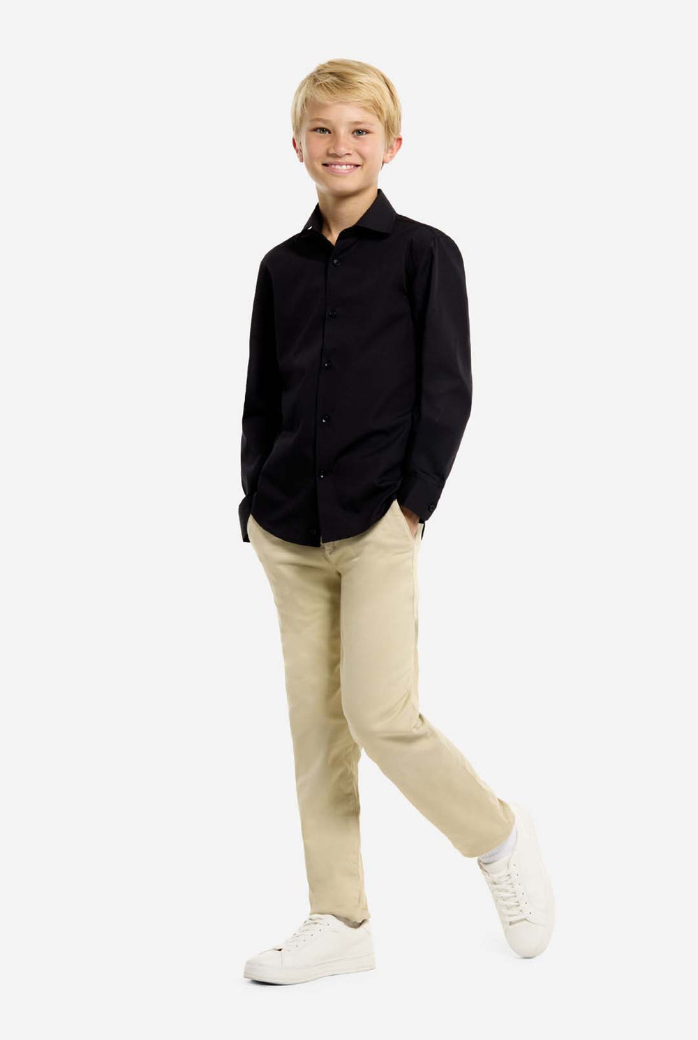 Person wearing a black shirt and beige pants on a white background