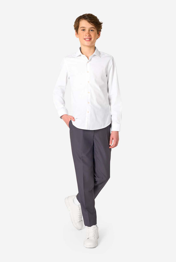 Image of long sleeve white shirt for boys worn by teen. Also wearing black pants. Full body image.