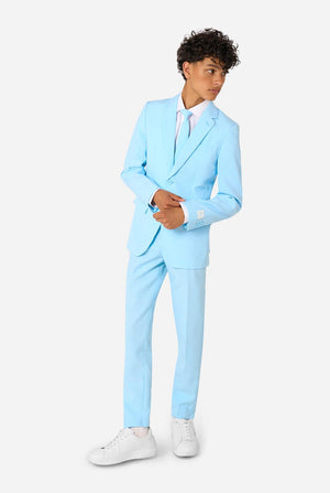 Teen wearing a light blue suit with a white shirt and tie on a light background. Full body image.