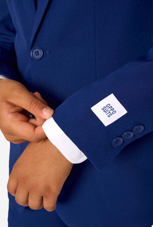Close-up of a blue suit jacket with a brand label on a white background