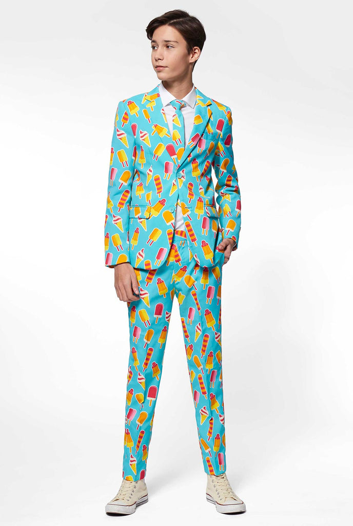 Teen wearing light blue formal suit with popsicle print
