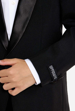 Close-up of a black tuxedo with 'OPPOSUITS' branding on the sleeve.