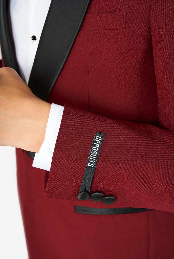 Teen wearing Burgundy red and black tuxedo, sleeve close up