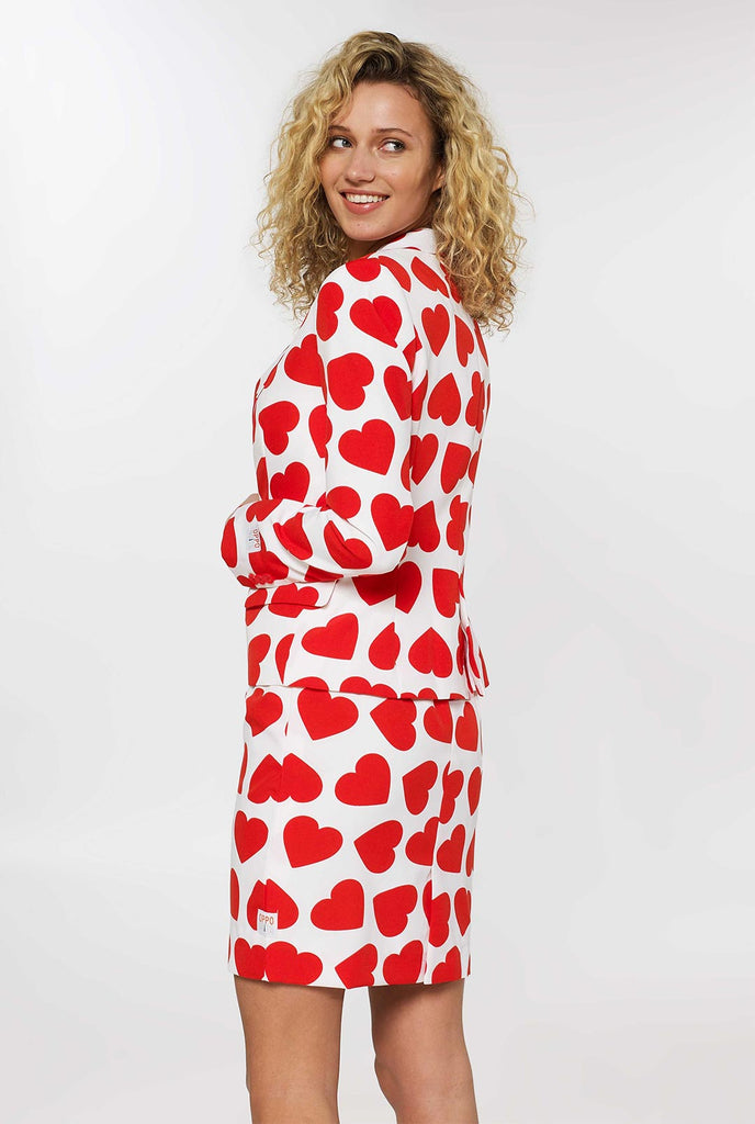 Woman wearing white Valentine's Day suit with red hearts