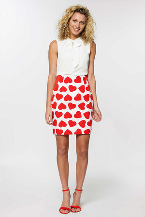 Woman wearing white Valentine's Day suit with red hearts