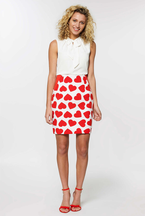 Woman wearing white Valentine's Day suit with red hearts