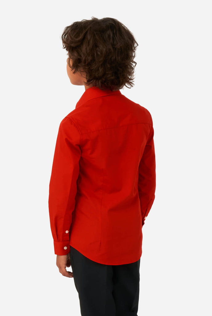 Boy wearing red dress shirt and black pants, view from the back