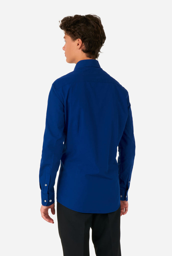 Teen wearing blue dress shirt and black pants, view from the back
