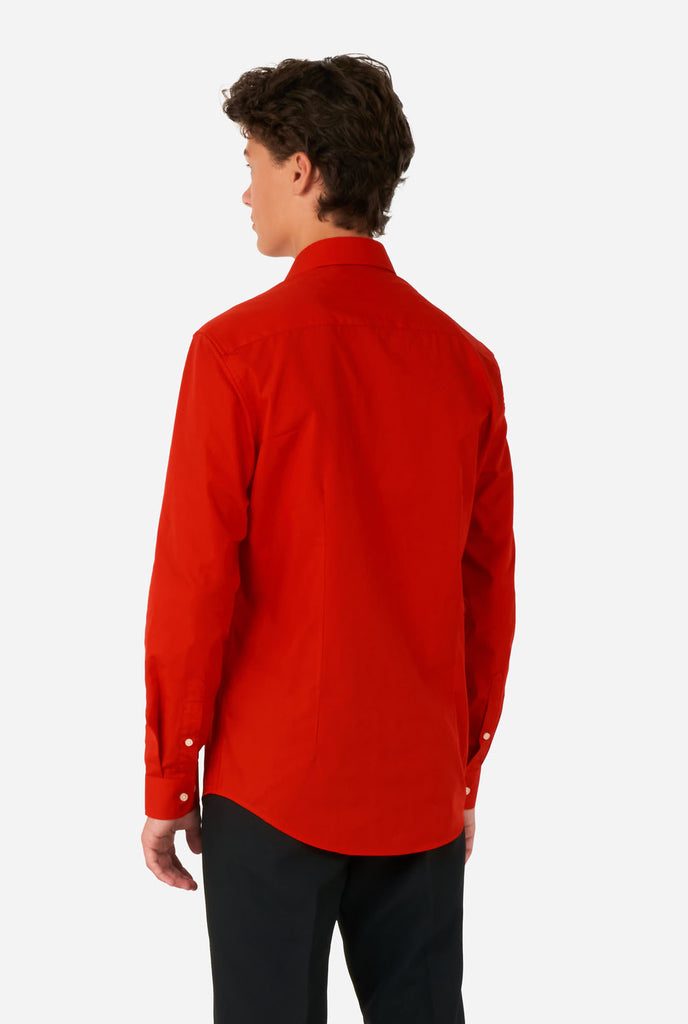 Teen wearing red dress shirt and black pants, view from the back