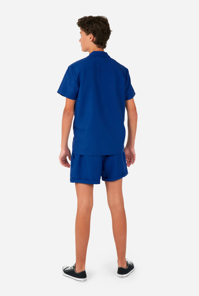 Teen wearing blue summer set, consisting of shirt and short., view from the back