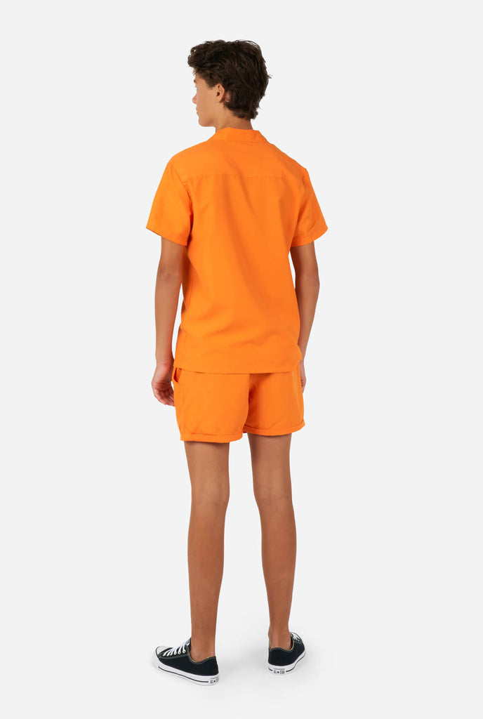 Teen wearing orange summer set, consisting of shirt and short., view from the back