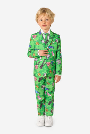 Full-body image of a kid in a green Minecraft-themed suit by OppoSuits, smiling and posing confidently.