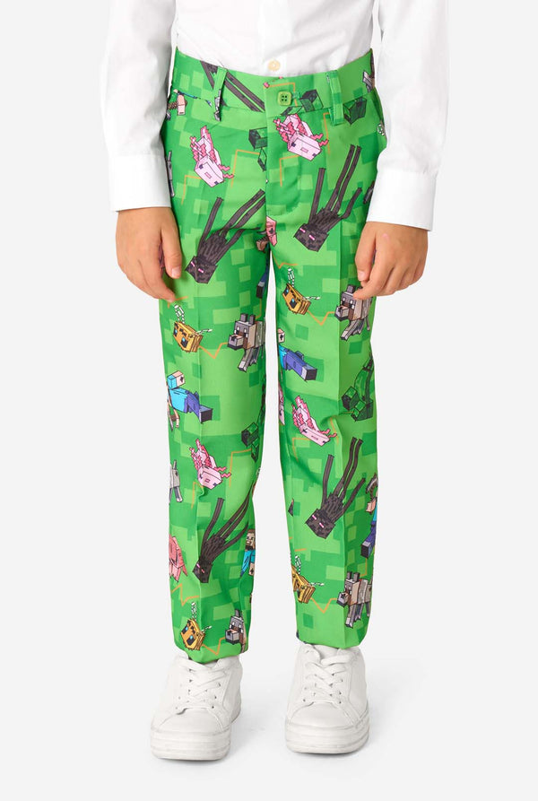 Close-up of Minecraft suit trousers featuring Creepers, pigs, and wolves in a pixel-style print, worn by kid.