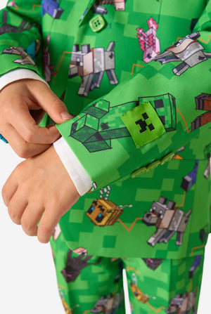 Detailed sleeve close-up of Minecraft-themed blazer, highlighting vibrant characters and green buttons, worn by kid.
