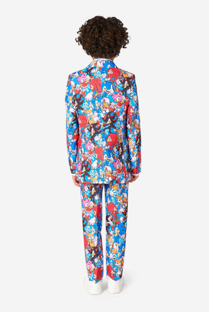 Young boy wearing a vibrant Sonic teen suit featuring colorful prints of Sonic the Hedgehog characters including Sonic, Knuckles, Tails, and Amy, paired with a matching tie and white shirt. View from the back.