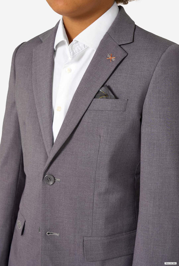 Close-up of the blazer chest area showing a black and yellow pocket square and an orange cross stitch near the lapel.