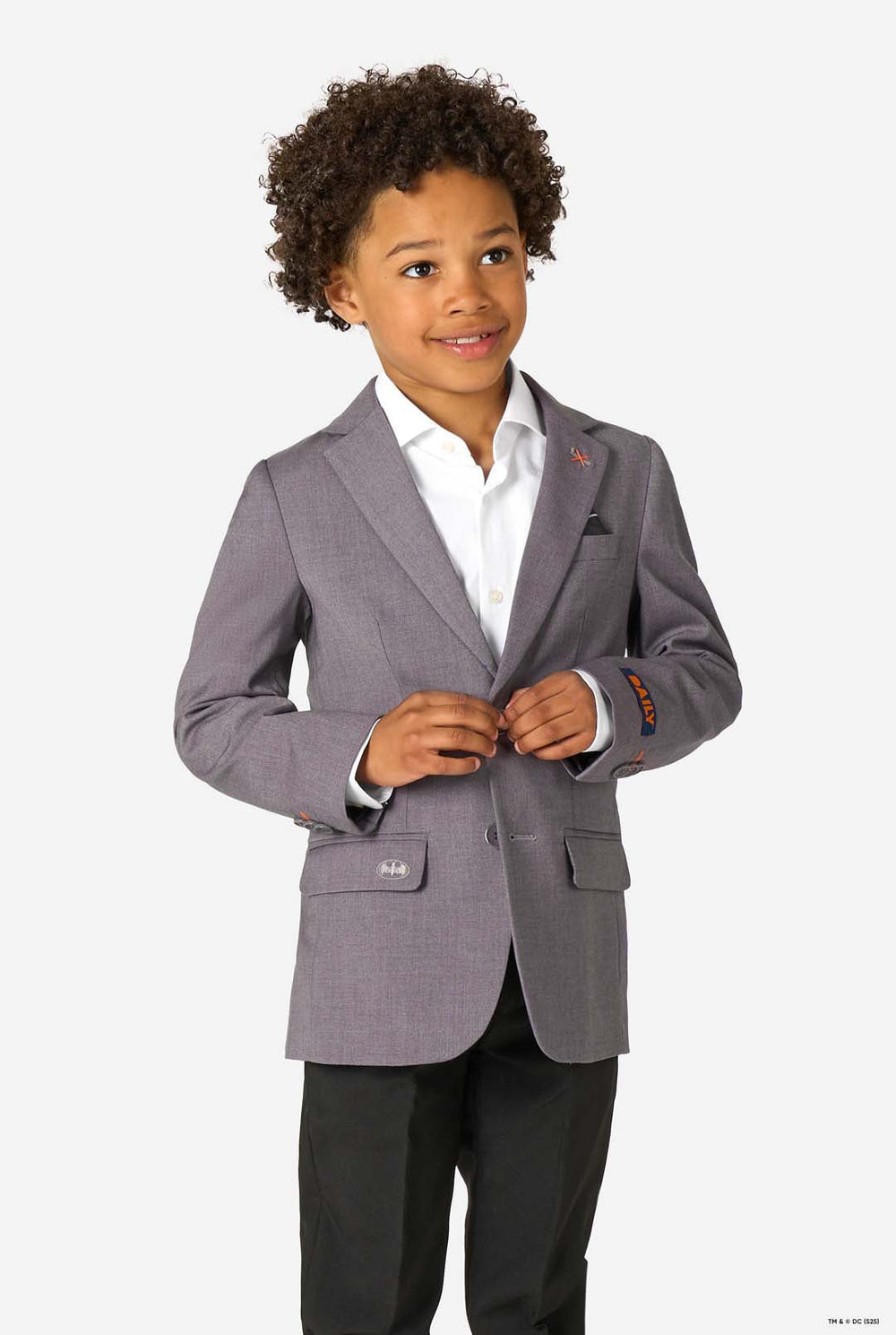 Child wearing a gray suit with a white shirt on a white background