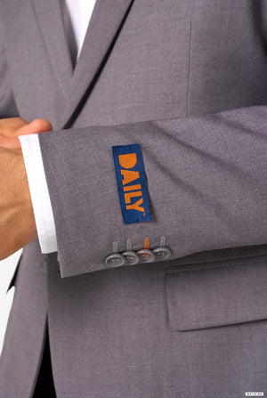 Gray suit with a visible brand label on the cuff