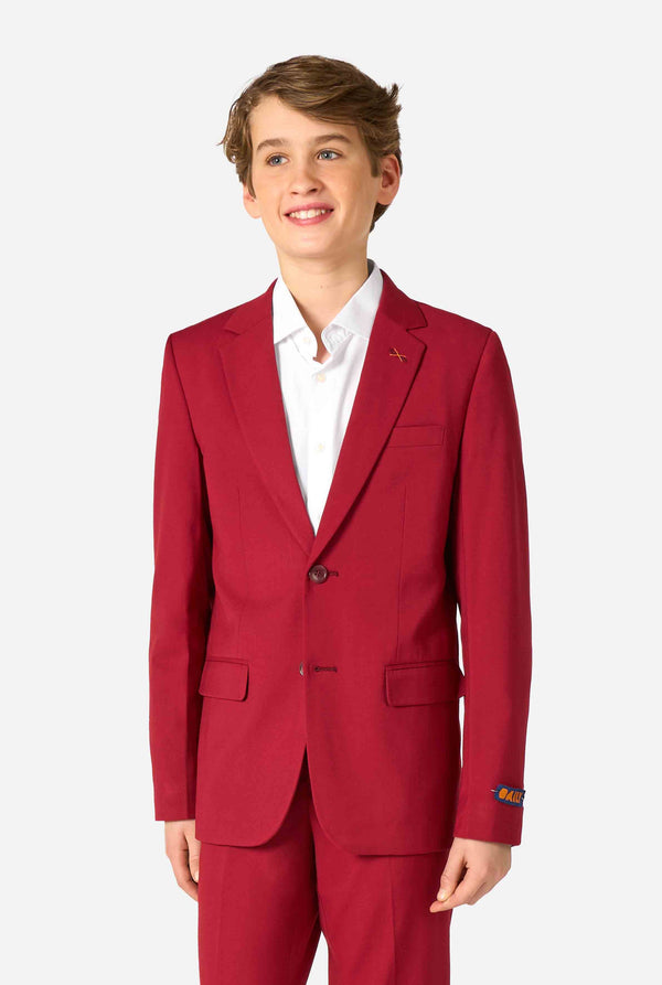 Teen boy wearing a stylish burgundy red suit with a white dress shirt, looking confidently. Perfect formal outfit for boys' special occasions, weddings, and parties.