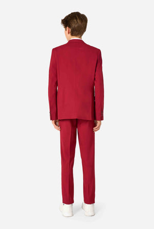 Teen boy wearing a stylish burgundy red suit with a white dress shirt, looking confidently. Perfect formal outfit for boys' special occasions, weddings, and parties. View from the back.