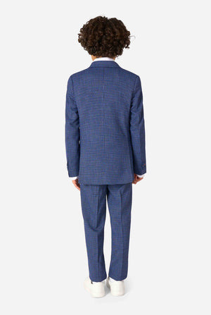 A boy wearing a navy and blue checkered suit with a white dress shirt. The suit has a modern fit with two buttons and flap pockets. He stands against a plain white background. View from the back.