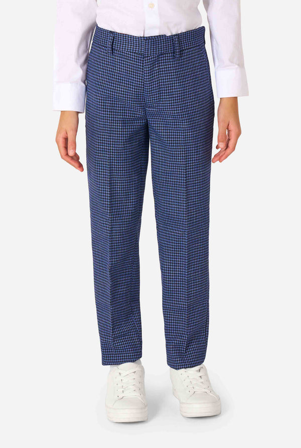 A boy wearing a navy and blue checkered suit with a white dress shirt. The suit has a modern fit with two buttons and flap pockets. He stands against a plain white background. Close up of the pants.