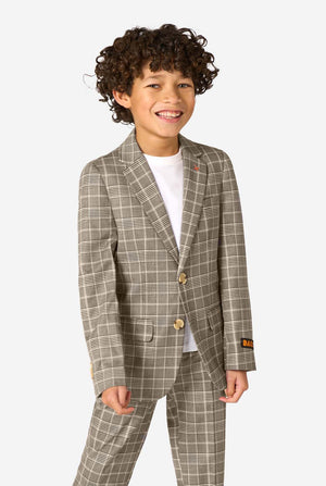 A boy wearing a tan checkered suit with a white dress shirt. The suit has a modern fit with two buttons and flap pockets. He stands against a plain white background.