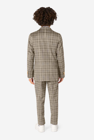 A boy wearing a tan checkered suit with a white dress shirt. The suit has a modern fit with two buttons and flap pockets. He stands against a plain white background. View from the back.