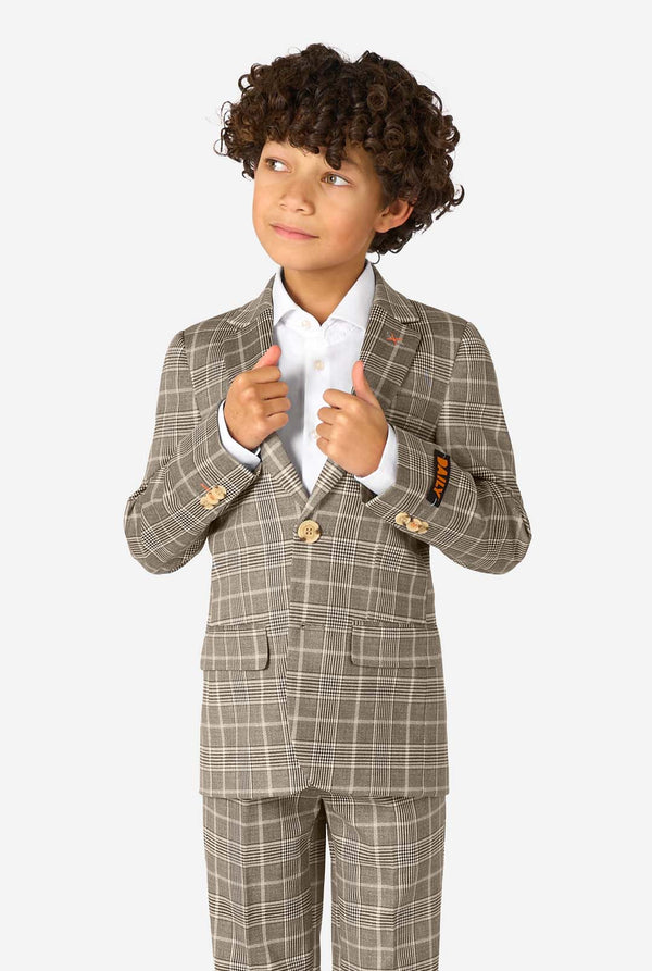 A boy wearing a tan checkered suit with a white dress shirt. The suit has a modern fit with two buttons and flap pockets. He stands against a plain white background.