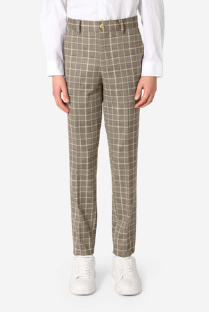 A young boy stands smiling while wearing a formal tan and beige plaid suit jacket over a white button-down shirt. The suit features a subtle check pattern. Close up of the pants