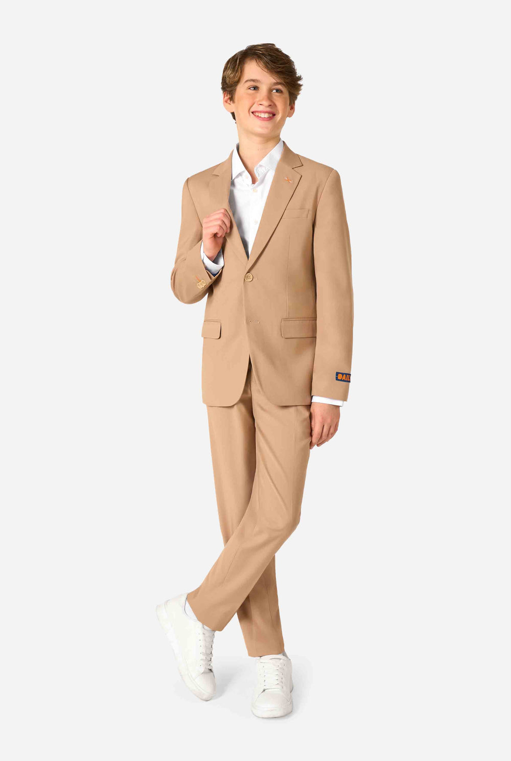Teen boy wearing a stylish light brown/ beige suit with a white dress shirt, looking confidently in the camera. Perfect formal outfit for boys' special occasions, weddings, and parties.