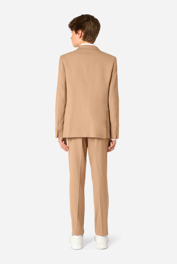 Teen boy wearing a stylish light brown/ beige suit with a white dress shirt, looking confidently in the camera. Perfect formal outfit for boys' special occasions, weddings, and parties. View from the back.
