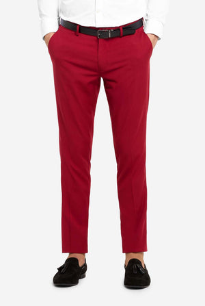 Image with light grey background and man wearing Bright Burgundy men’s suit and white shirt. Suits consists of blazer and pants. Focused on the pants.