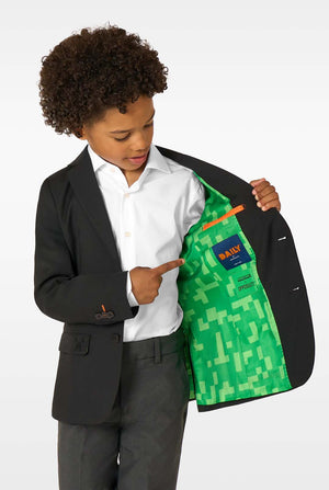 Child wearing a black blazer with a green patterned lining, pointing to the lining.