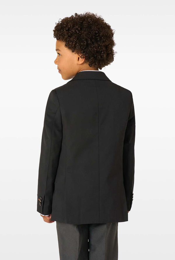 Child wearing a black suit jacket on a white background