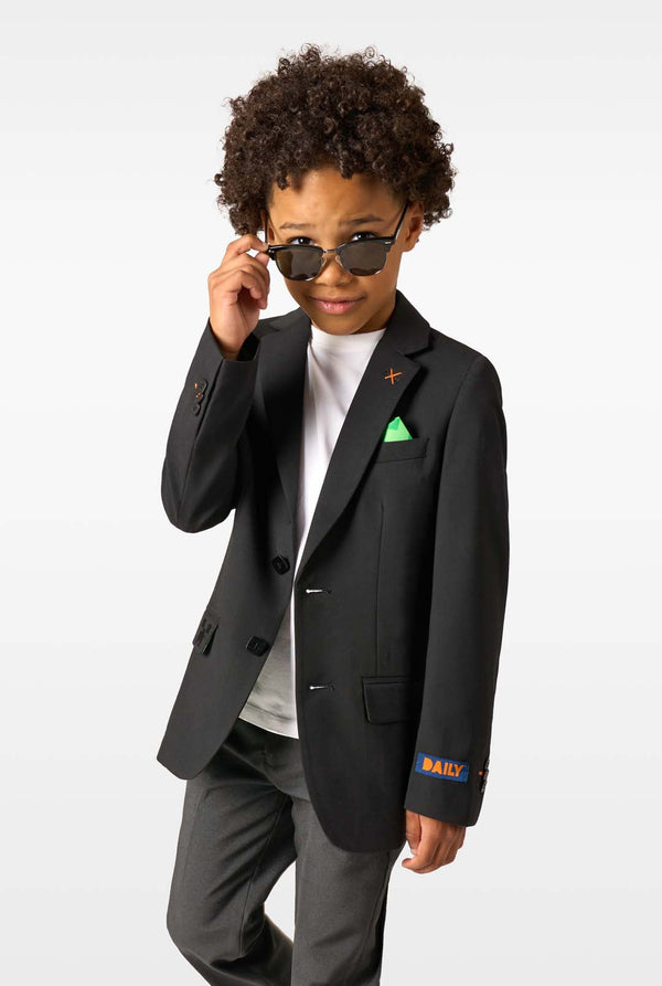 Child wearing a black blazer with visible branding on a white background