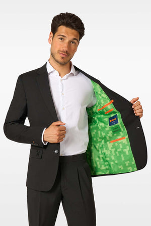 Man wearing a black suit with a green and orange patterned vest on a white background