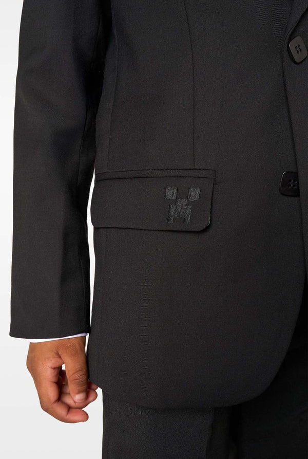 Black suit jacket with a logo patch on a white background
